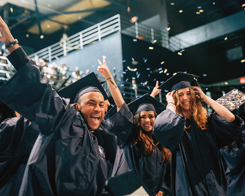 Three Students Celebrating after their commencement ceremony